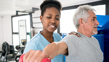 Women helping man medical setting