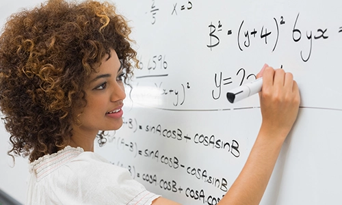 A woman writing on a white board