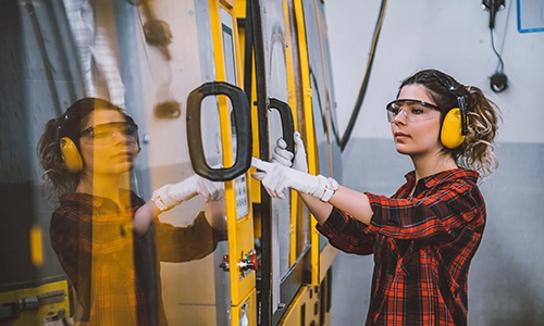 A woman using industrial equipment