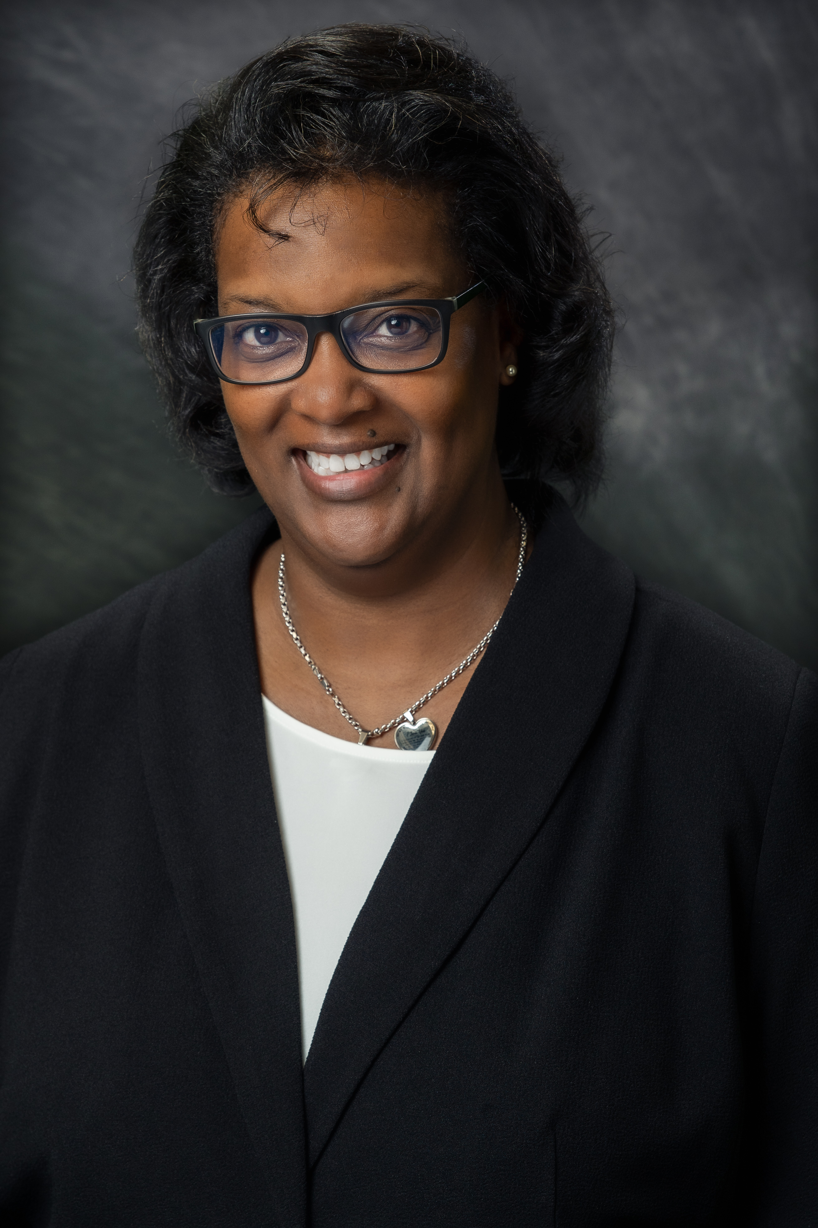 Chief Human Resources Officer Lisa Moore on grey background