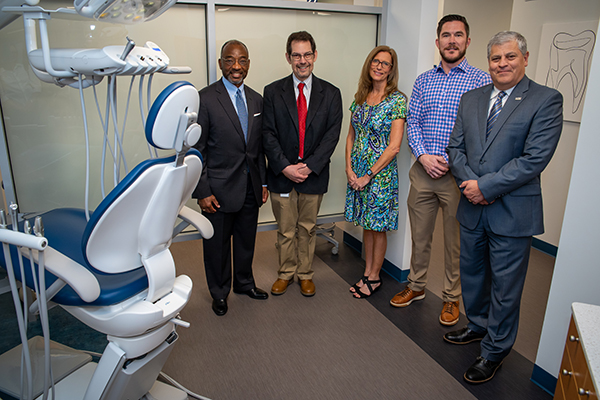 Group of people next to dental chair