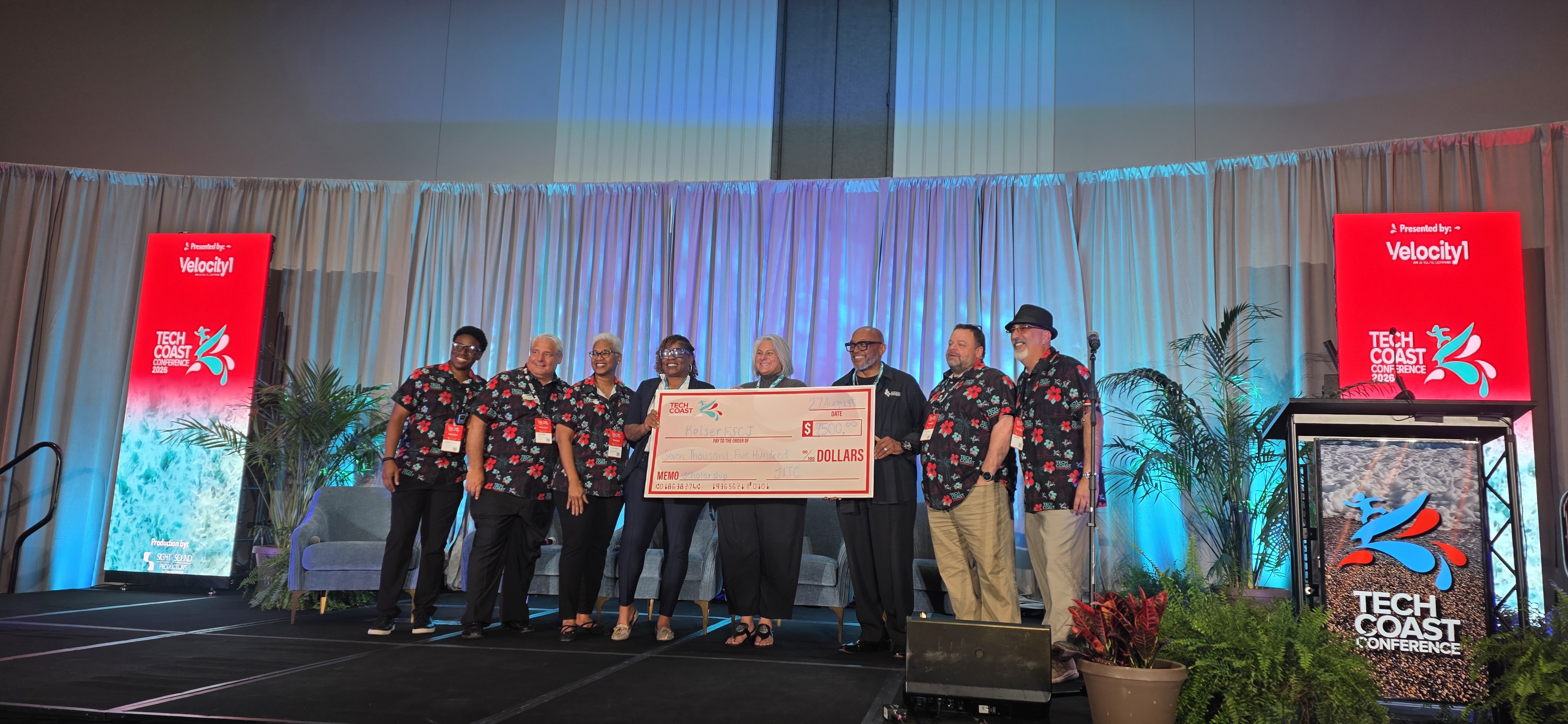 IT Scholarship Presentation FSCJ and Tech Coast representatives holding big scholarship check at presentation