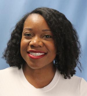 Brittani Fisher Brittani Fisher on a light blue background and wearing a white top