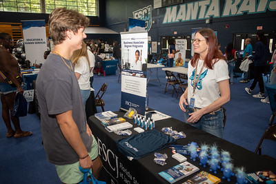 Student visiting the business table at Open House