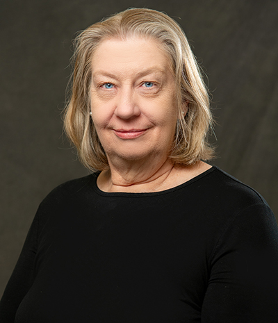 Jean Dealmeida Jean in black top on dark grey background