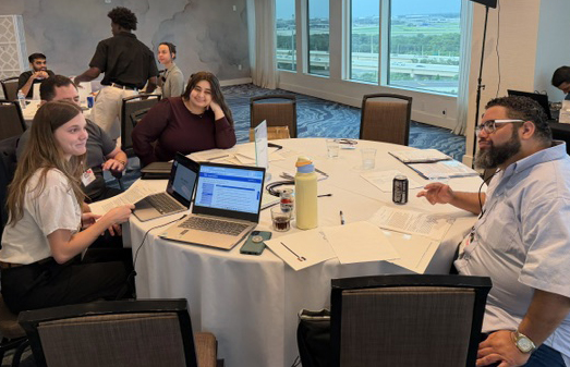 Kiarra and her group Kiarra and her group working on their presentation at a table