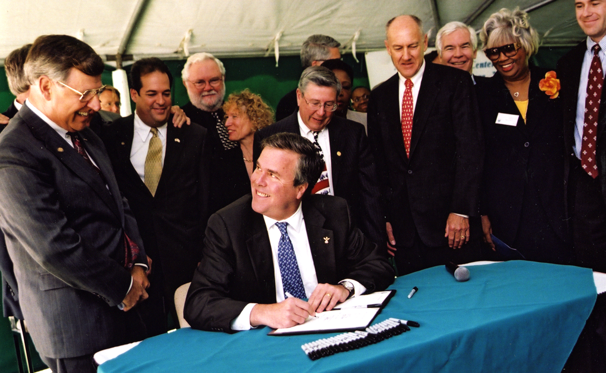 Photo of Gov. Jeb Bush signing legislation at the ATC dedication ceremony.