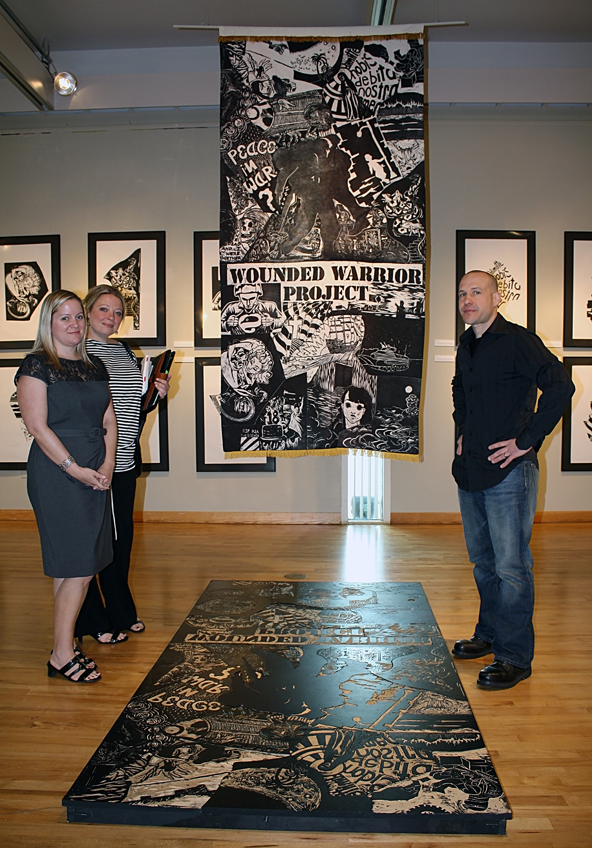 Photo of oversized print created at first Blocktoberfest in conjunction with Author Series; author Clint Van Winkle on right.