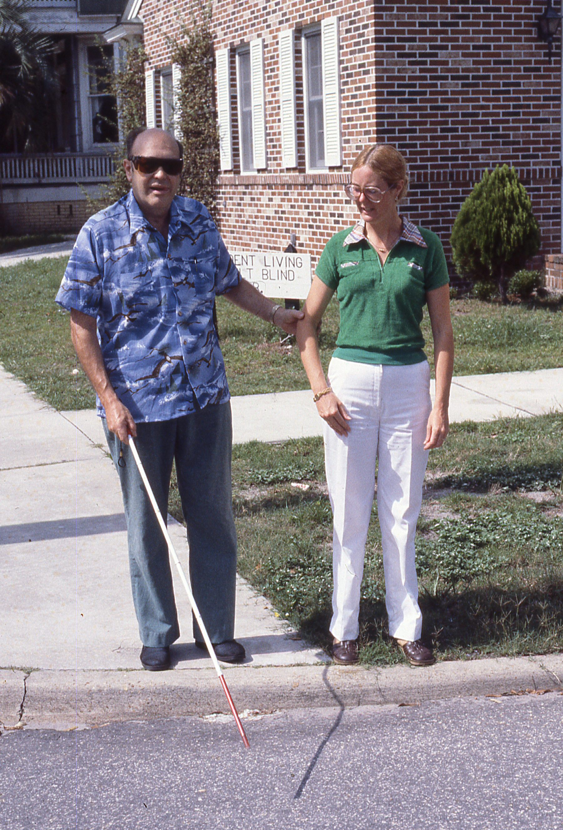 Photo of blind student on corner outside of iLAB building at 50 E. Second St.