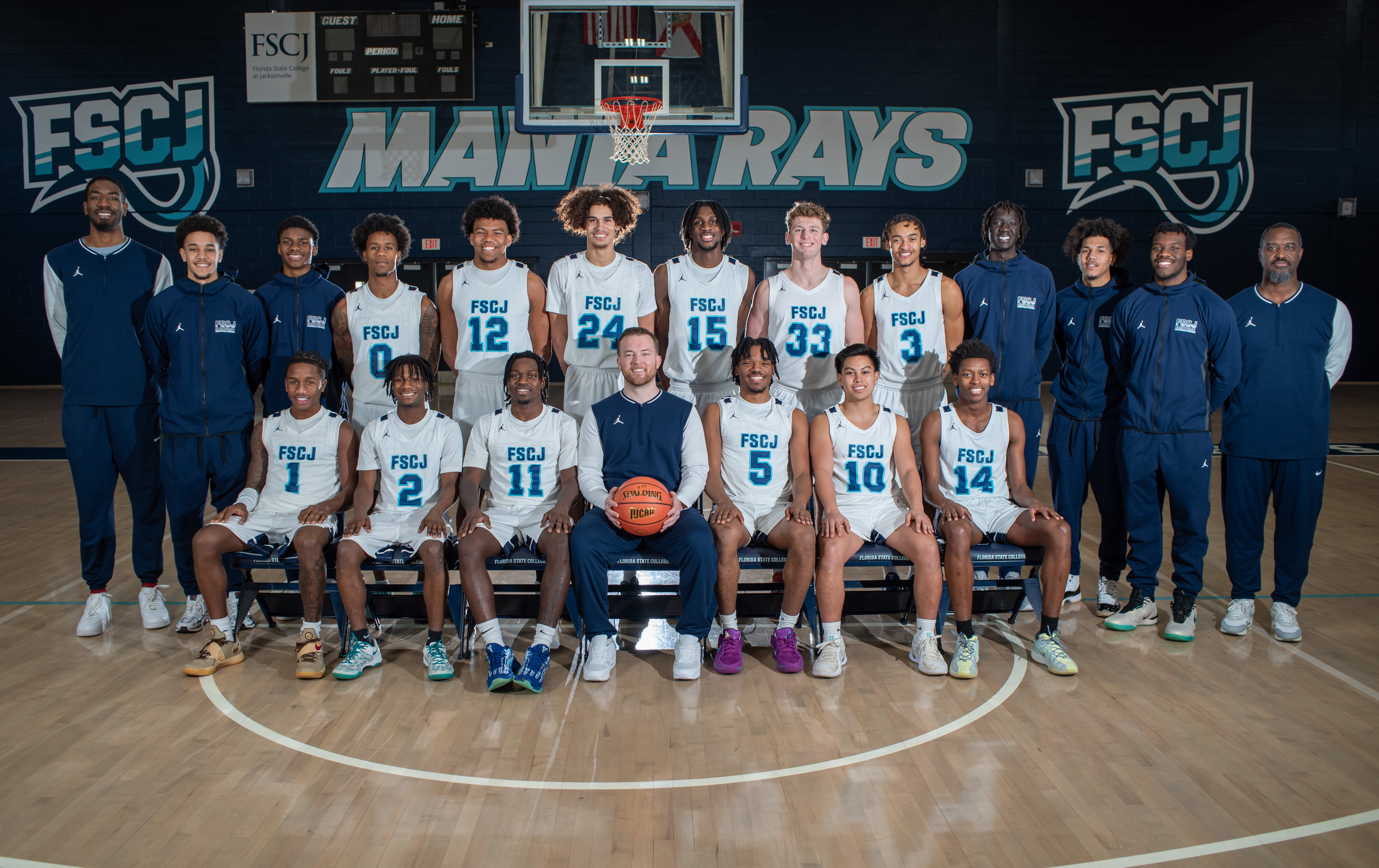 Basketball team sitting and facing forward