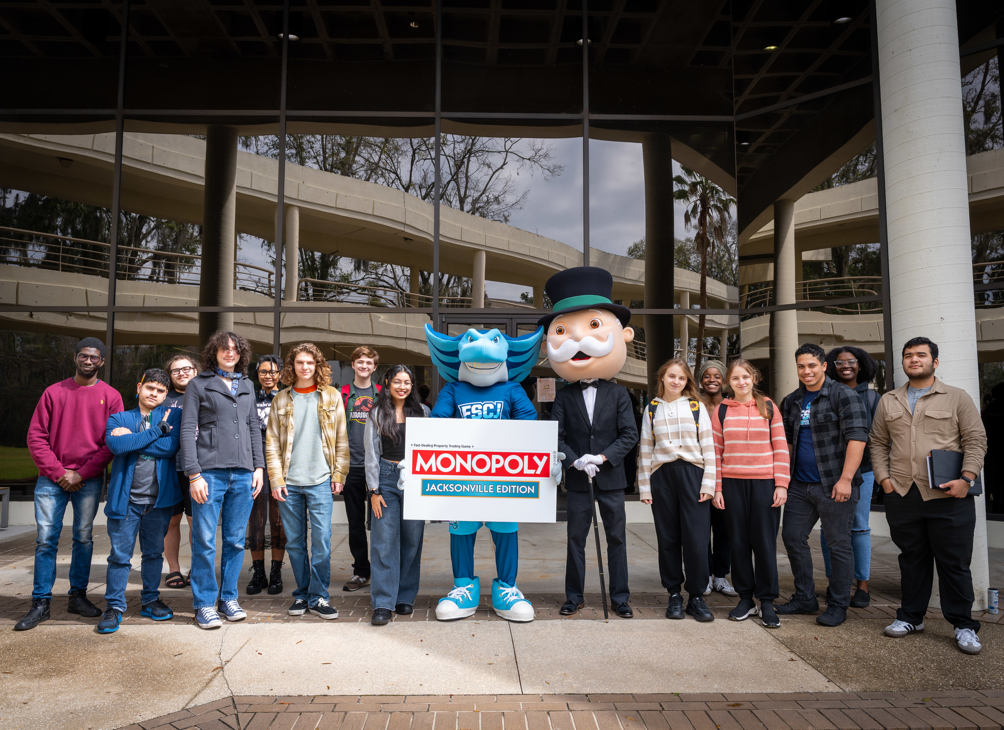 Crowd holding Monopoly card