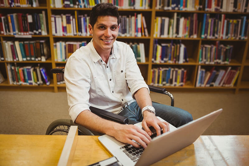 Man with laptop looking up