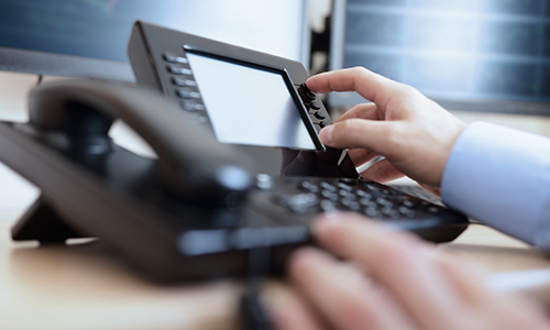 Close up of a person dialing a phone