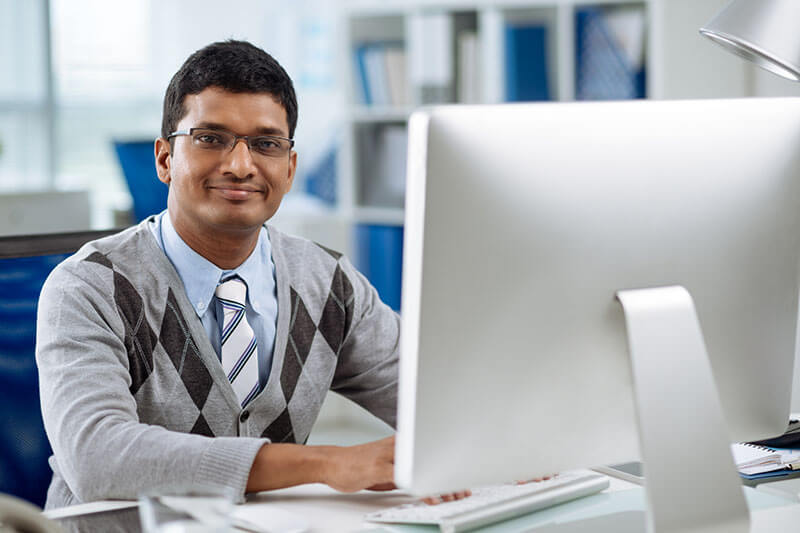 Man at desk behind computer