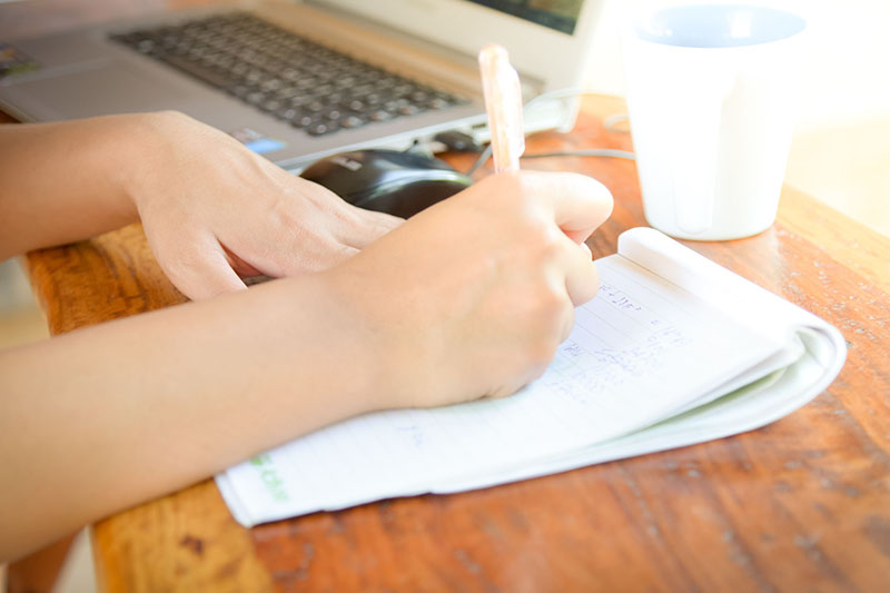 Person writing with pen