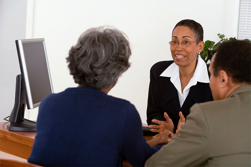 Three people talking in an office setting