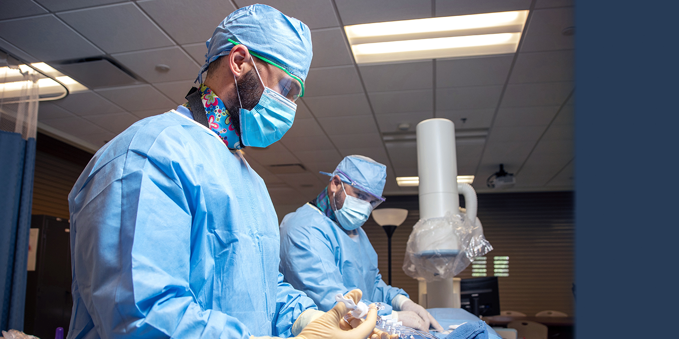 Two people in medical protective gear