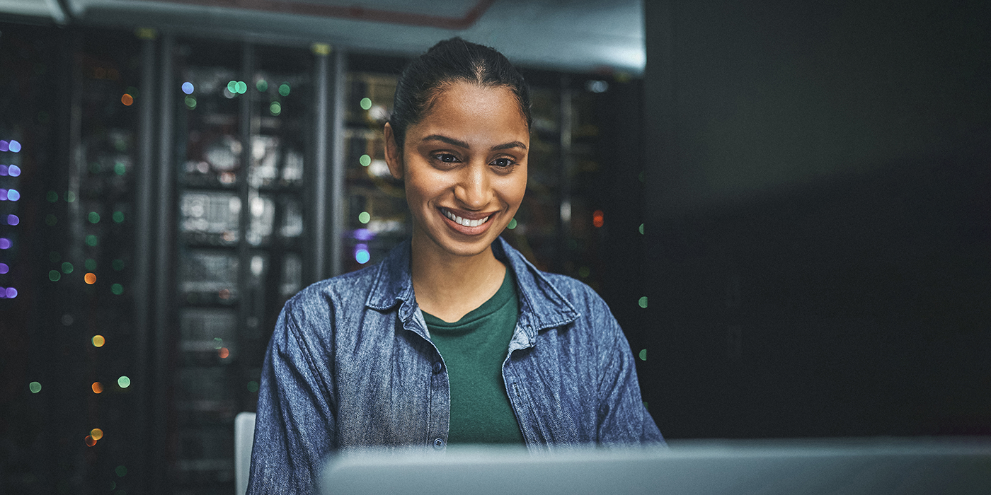 A smiling woman using a computer