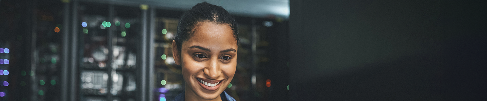 A smiling woman using a computer
