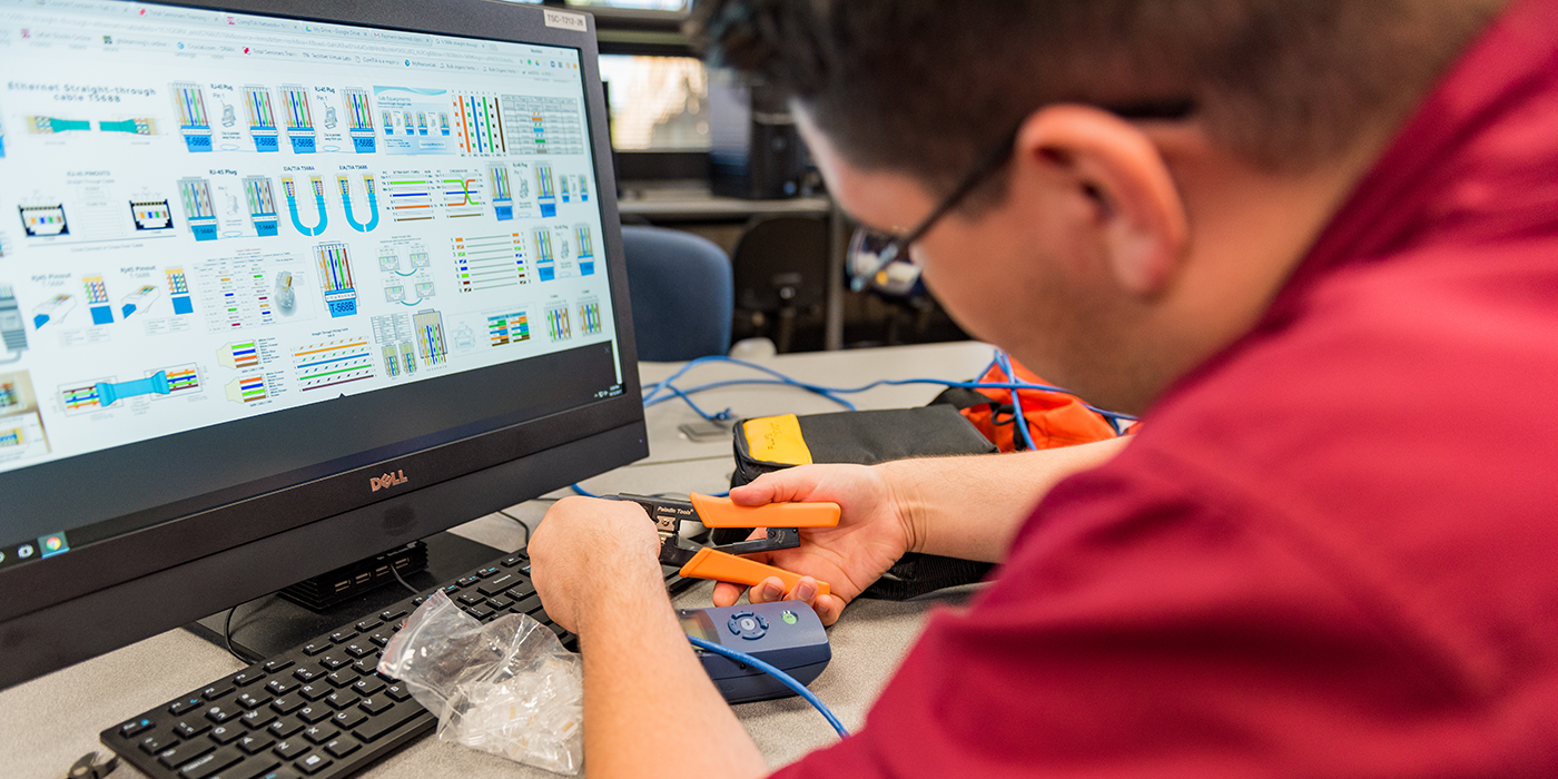 A person using an electrical crimp tool