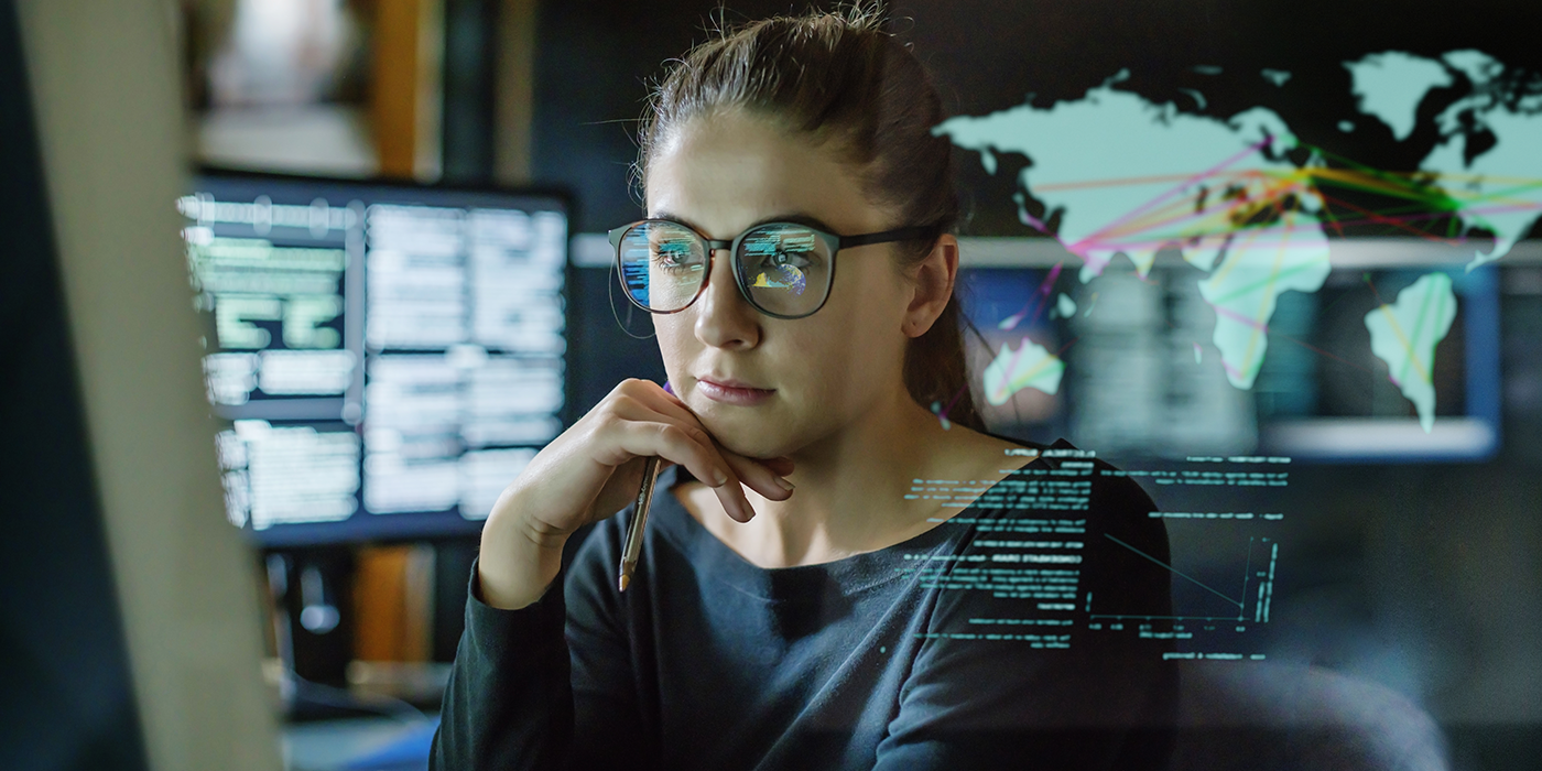 A woman using a computer with graphical overlays of global networking