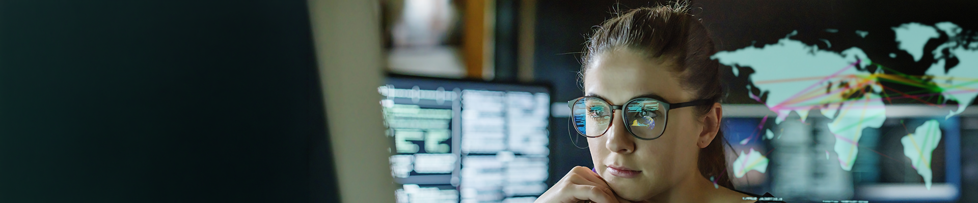 A woman using a computer with graphical overlays of global networking