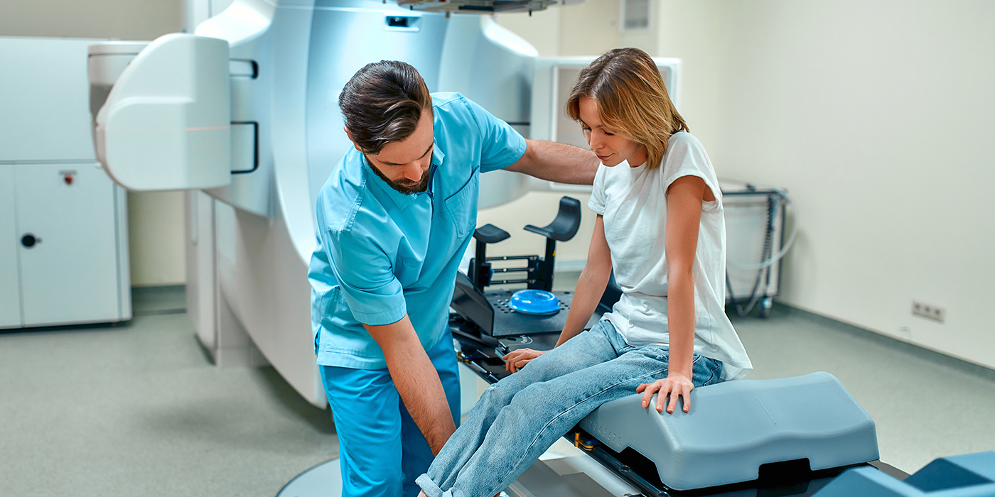 A man in medical scrubs attending to a patient