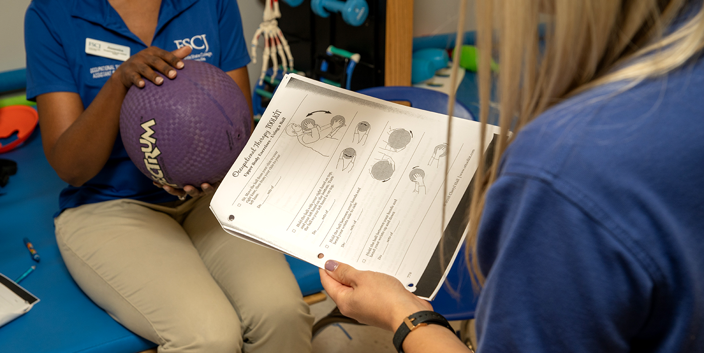A woman holding a medicine ball