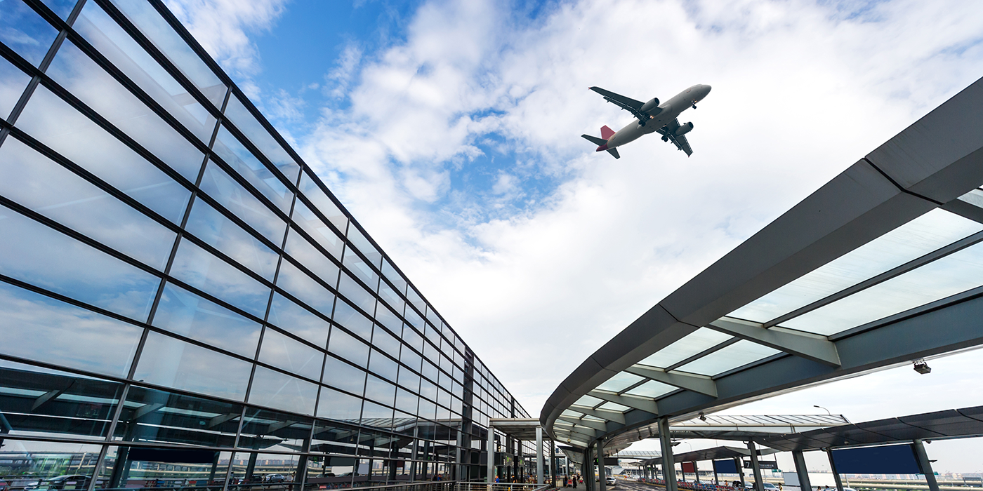 A passenger jet plane flying over buildings