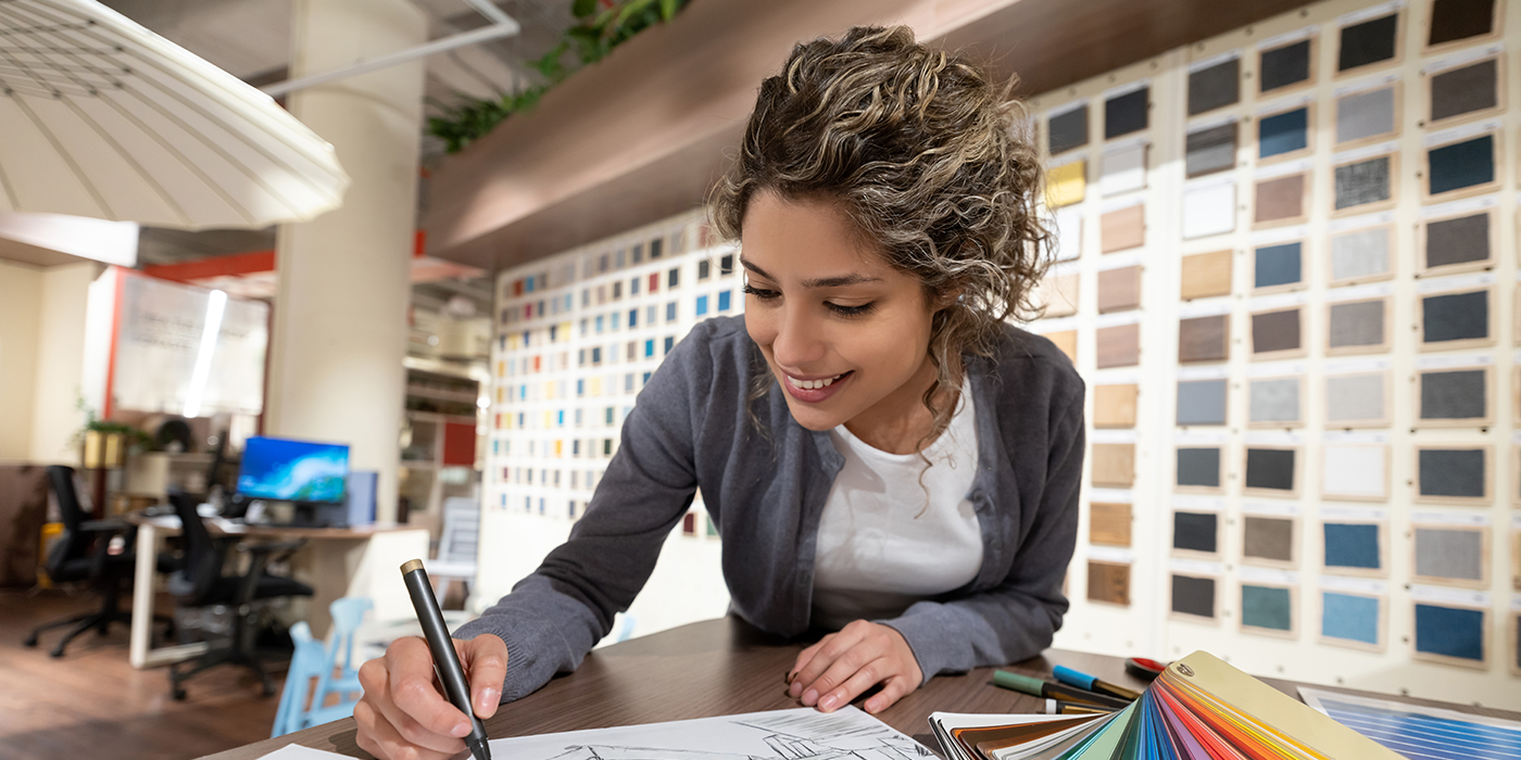 A woman in front of a color palette wall