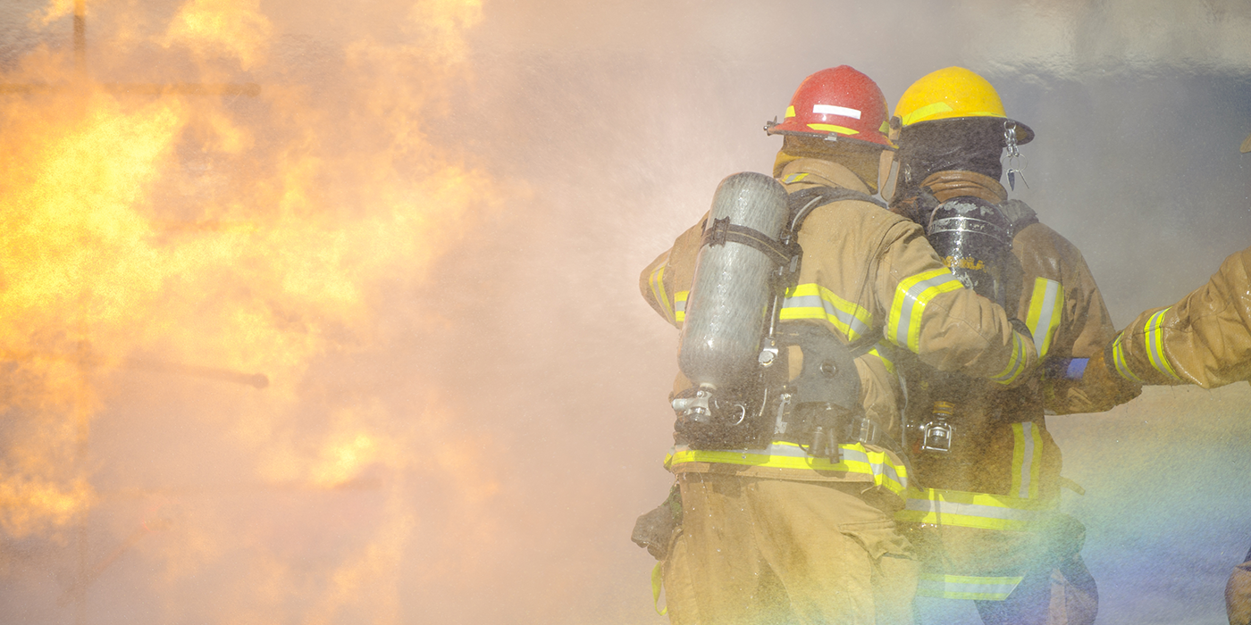 Firefighters in full protective gear fighting a fire