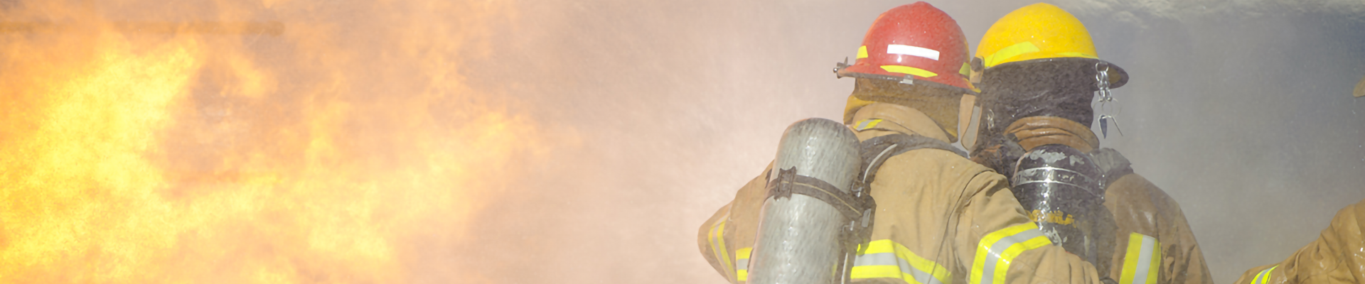 Firefighters in full protective gear fighting a fire