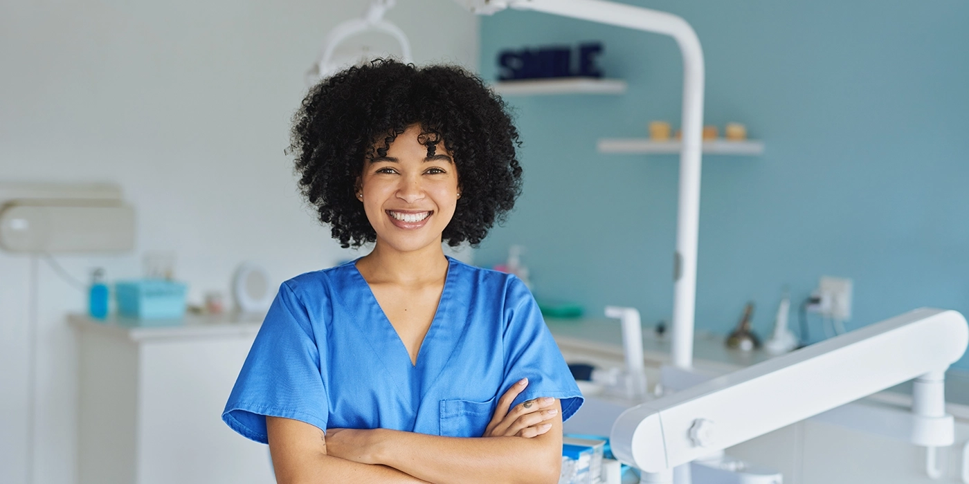 A woman in medical scrubs in a dentistry environment