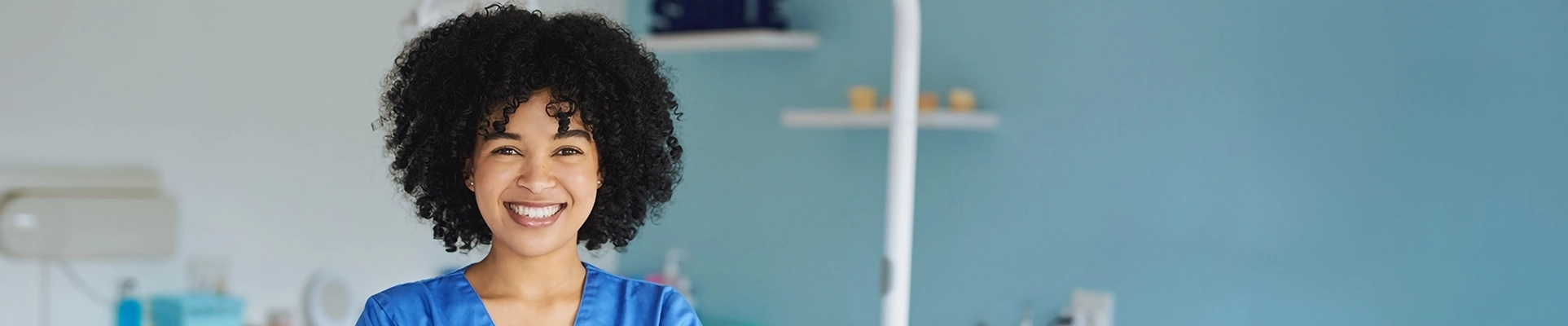A woman in medical scrubs in a dentistry environment