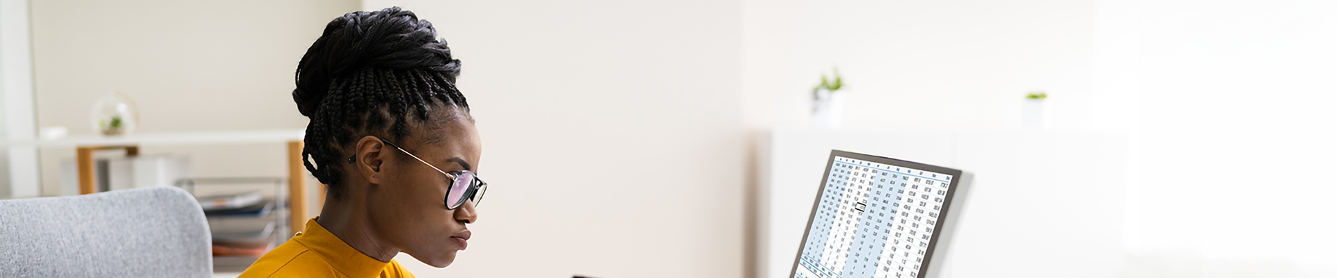 A person looking at spreadsheets on a computer