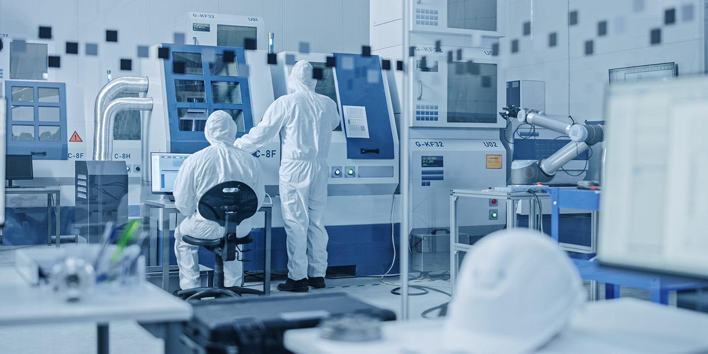 People in protective suits in a clean room environment