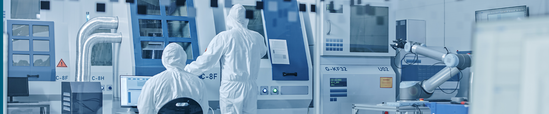 People in protective suits in a clean room environment