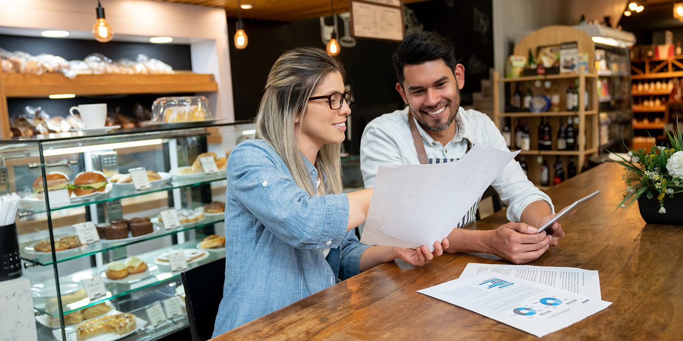 A woman and a man examining charts in a bake shop