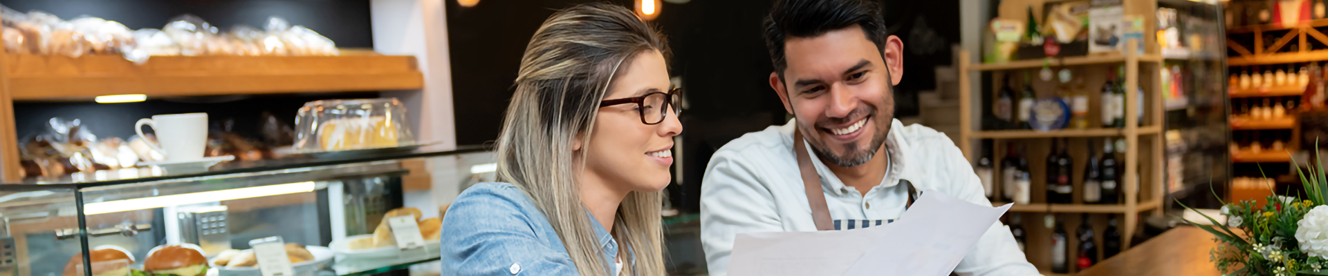 A woman and a man examining charts in a bake shop