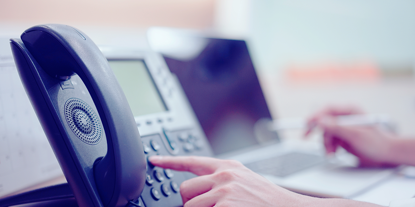 A person dialing a phone