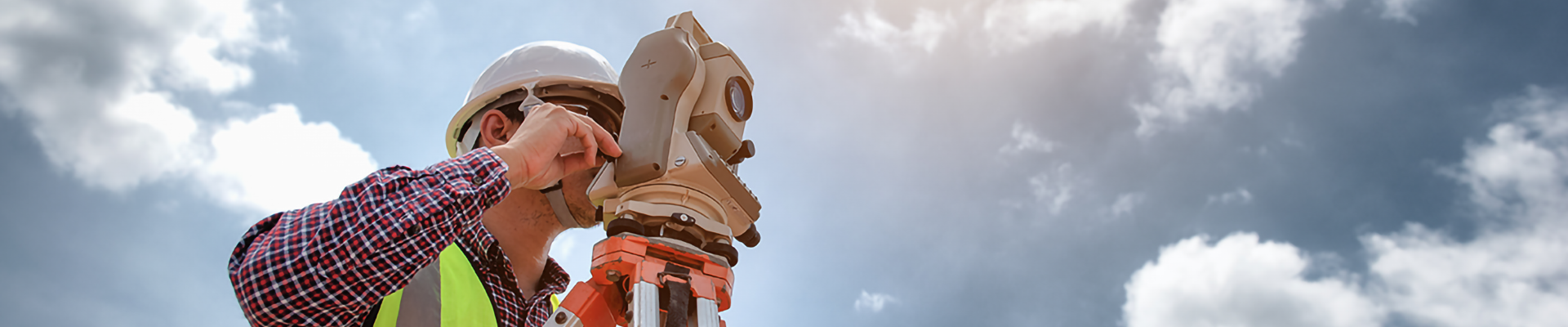 A person using surveying equipment