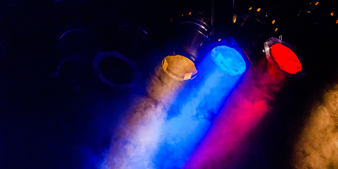 Three multi-colored stage lights