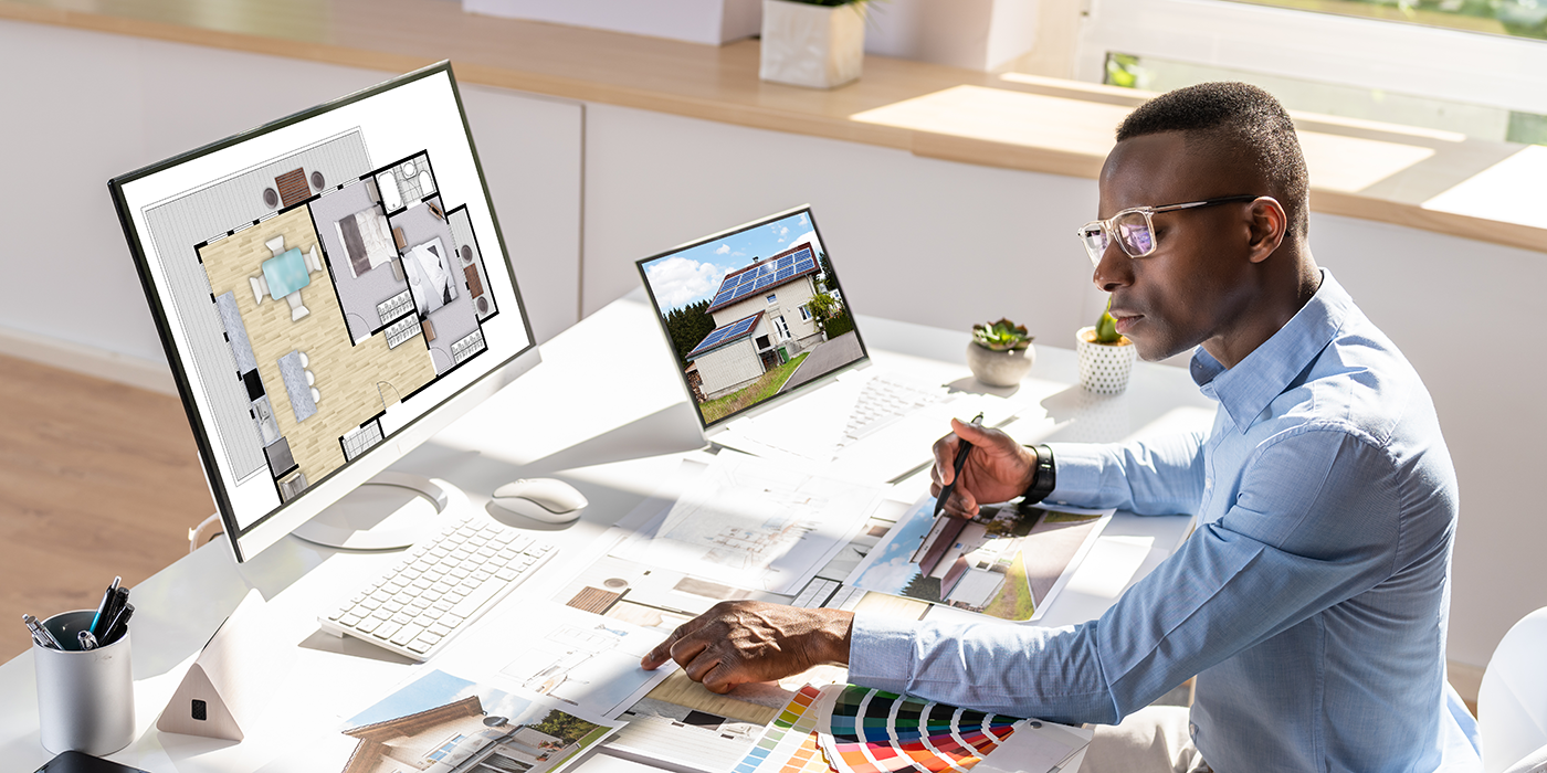A man using architectural design software on a computer