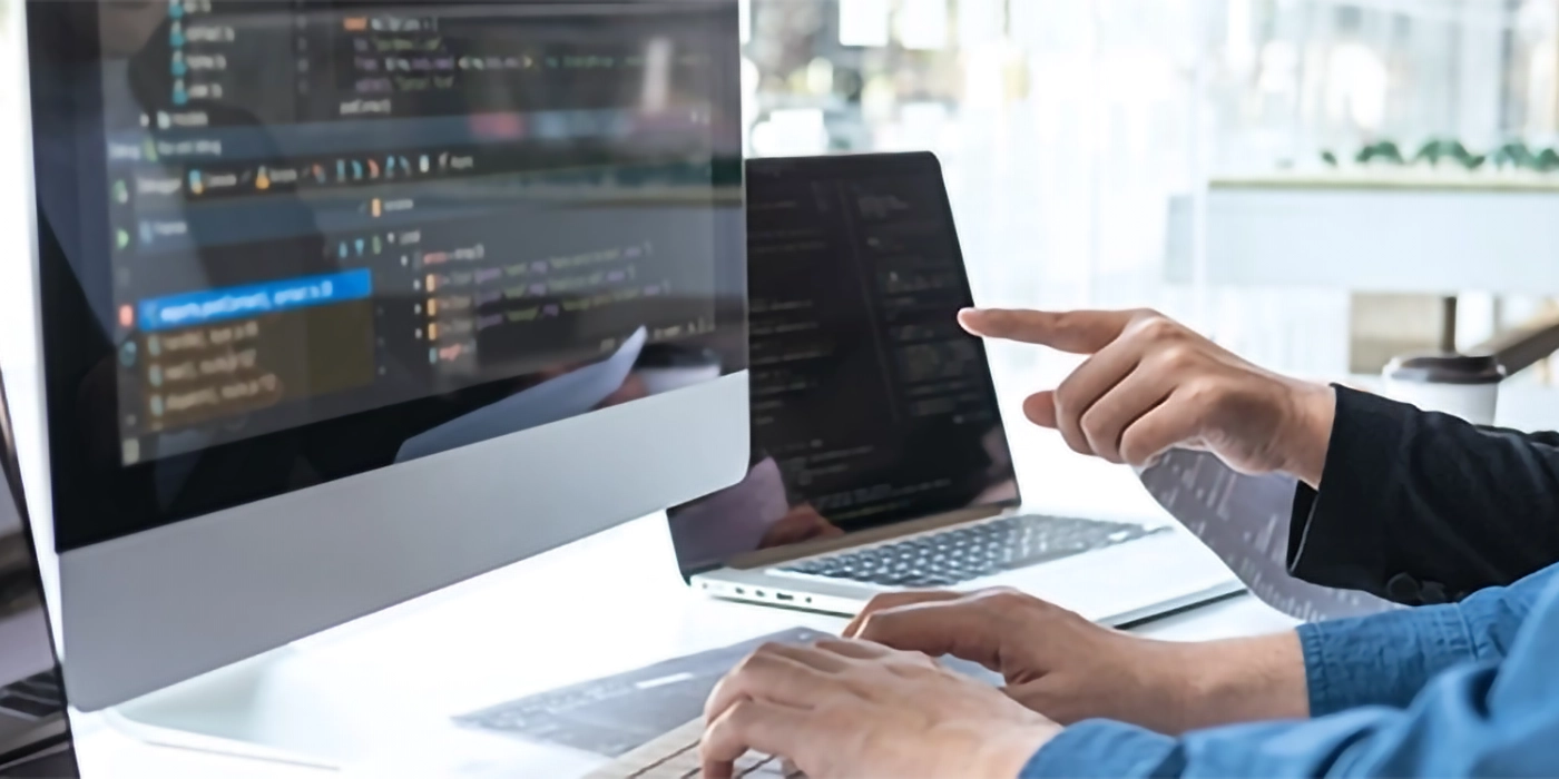 A person pointing at a computer screen