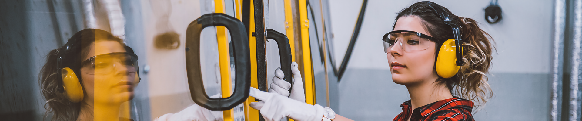 A woman using industrial machinery