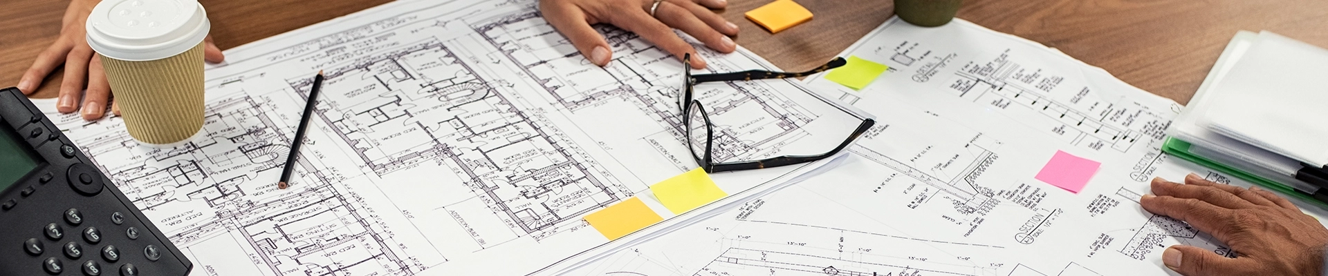 Multiple people analyzing papers in an office
