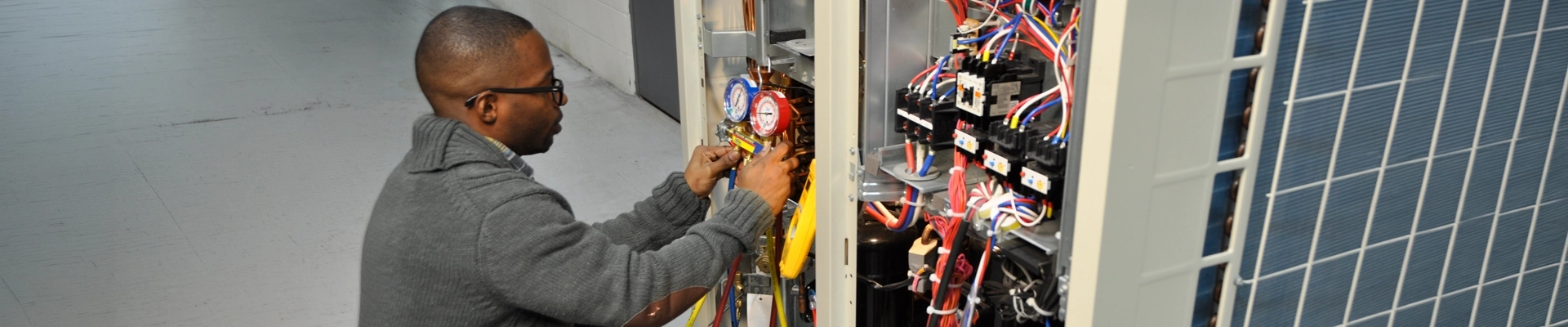 A man working on an air conditioning unit
