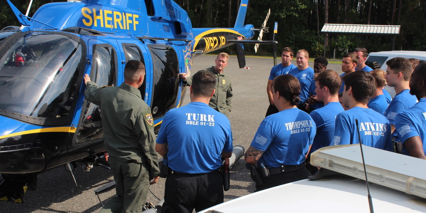 Students in front of helicopter