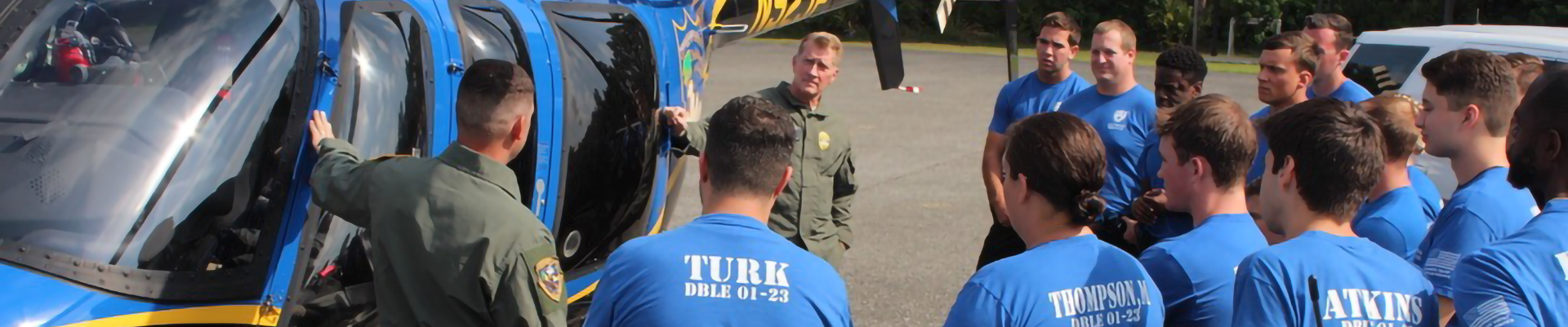 Students in front of helicopter