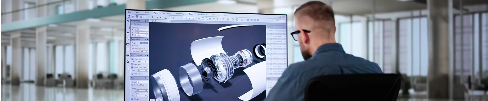 A man using 3D modeling software on a computer